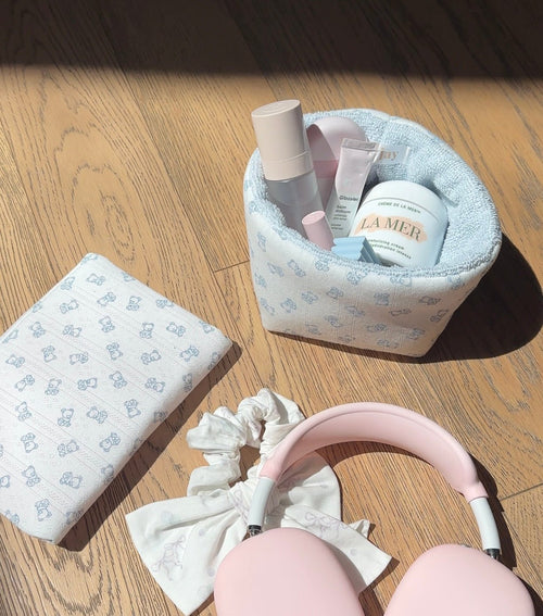 Baby blue teddy bear organizer pouch with patterned compartments and toiletries inside