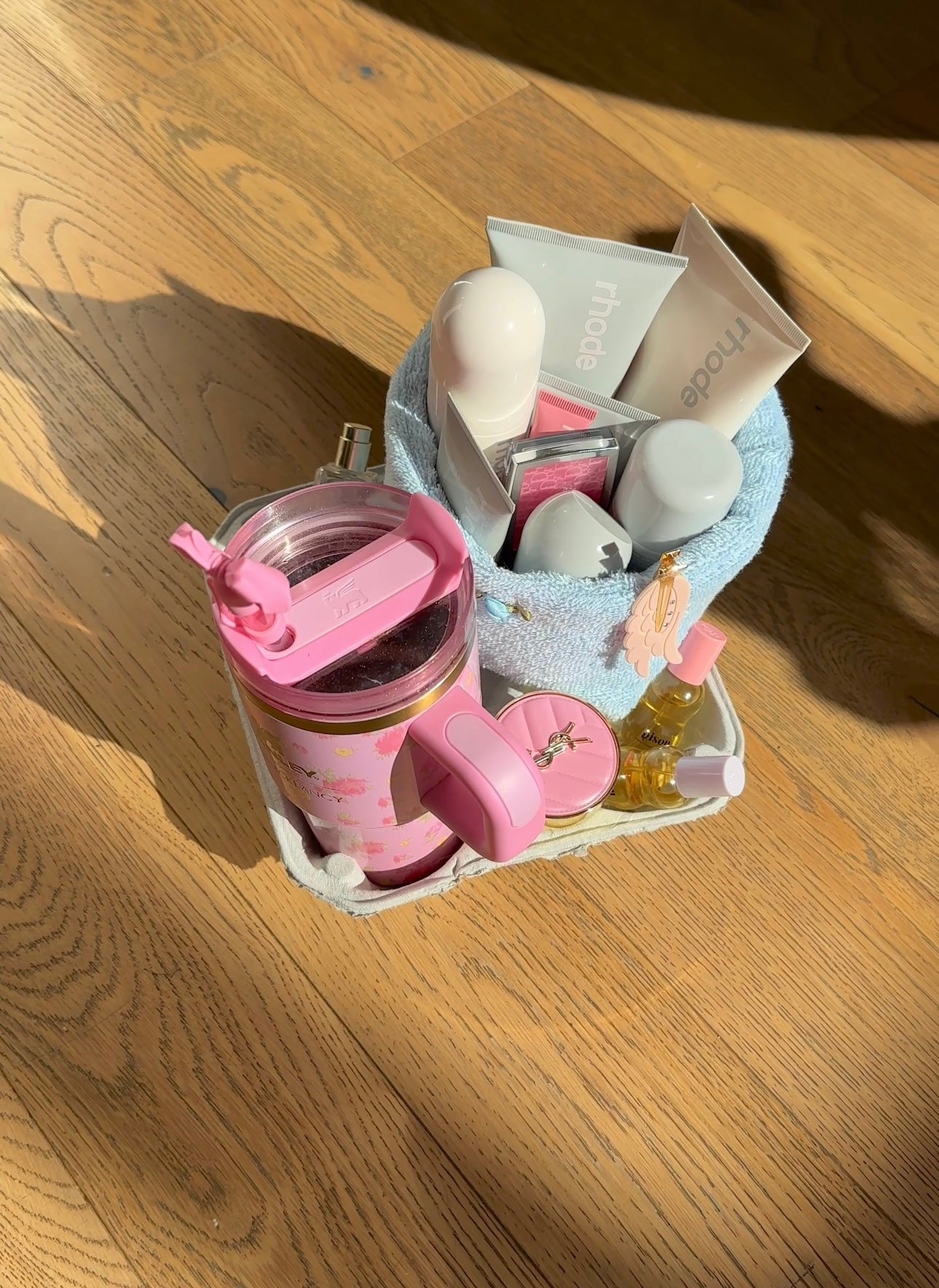 Baby blue terrycloth organizer with white pump bottles and tube packets