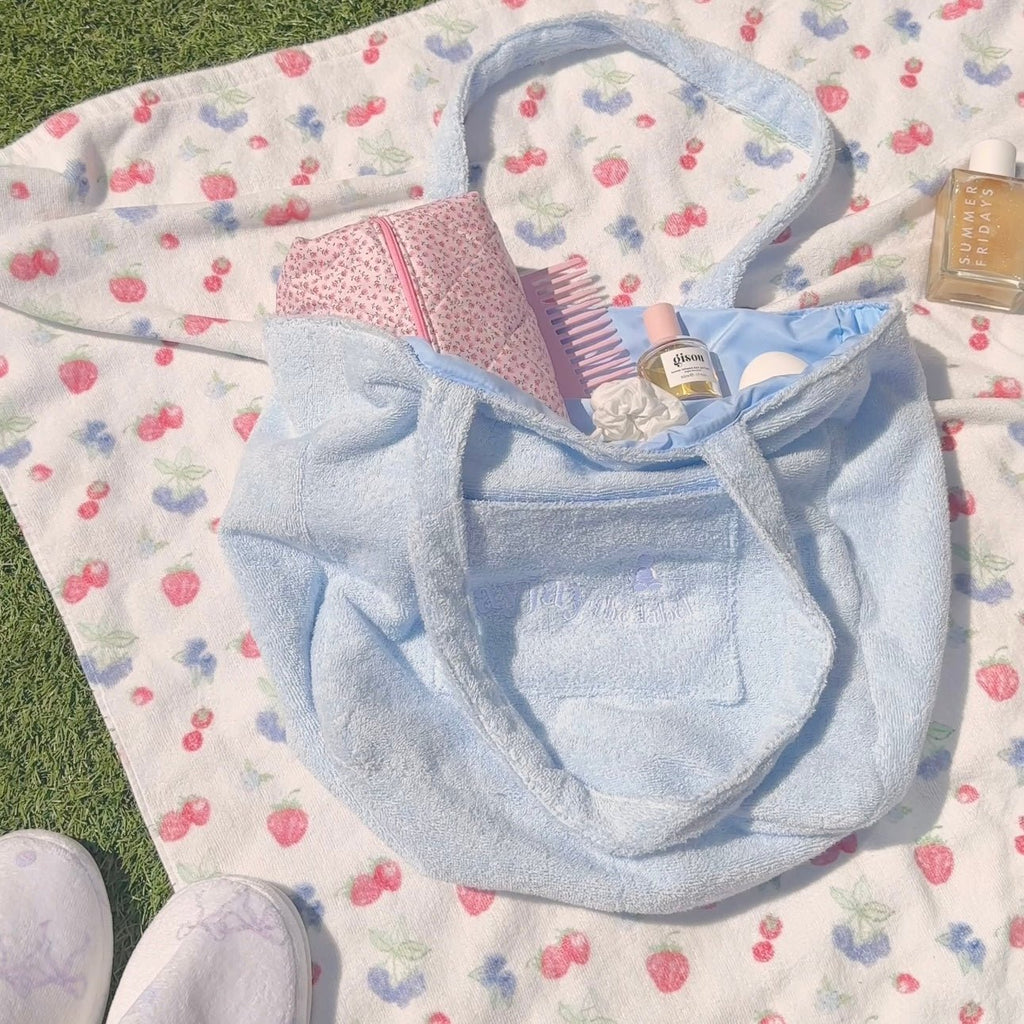 Light blue terrycloth tote bag with open mouth and stitched front panel pocket