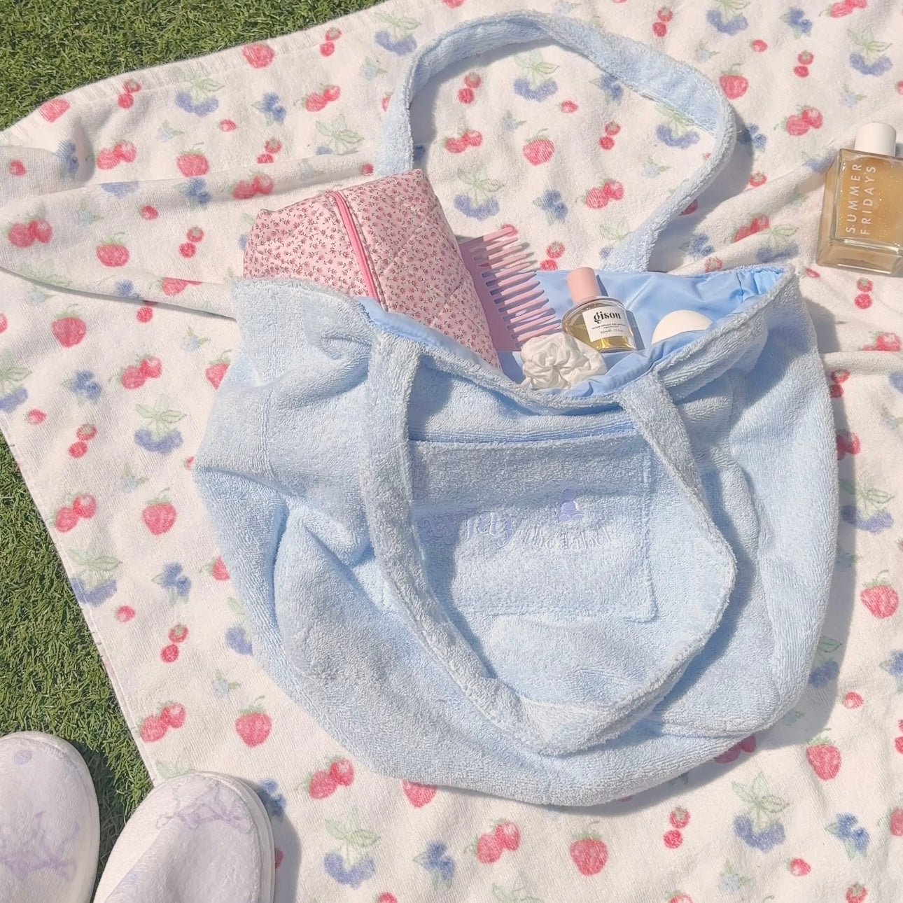 Light blue terrycloth tote bag with open mouth and stitched front panel pocket