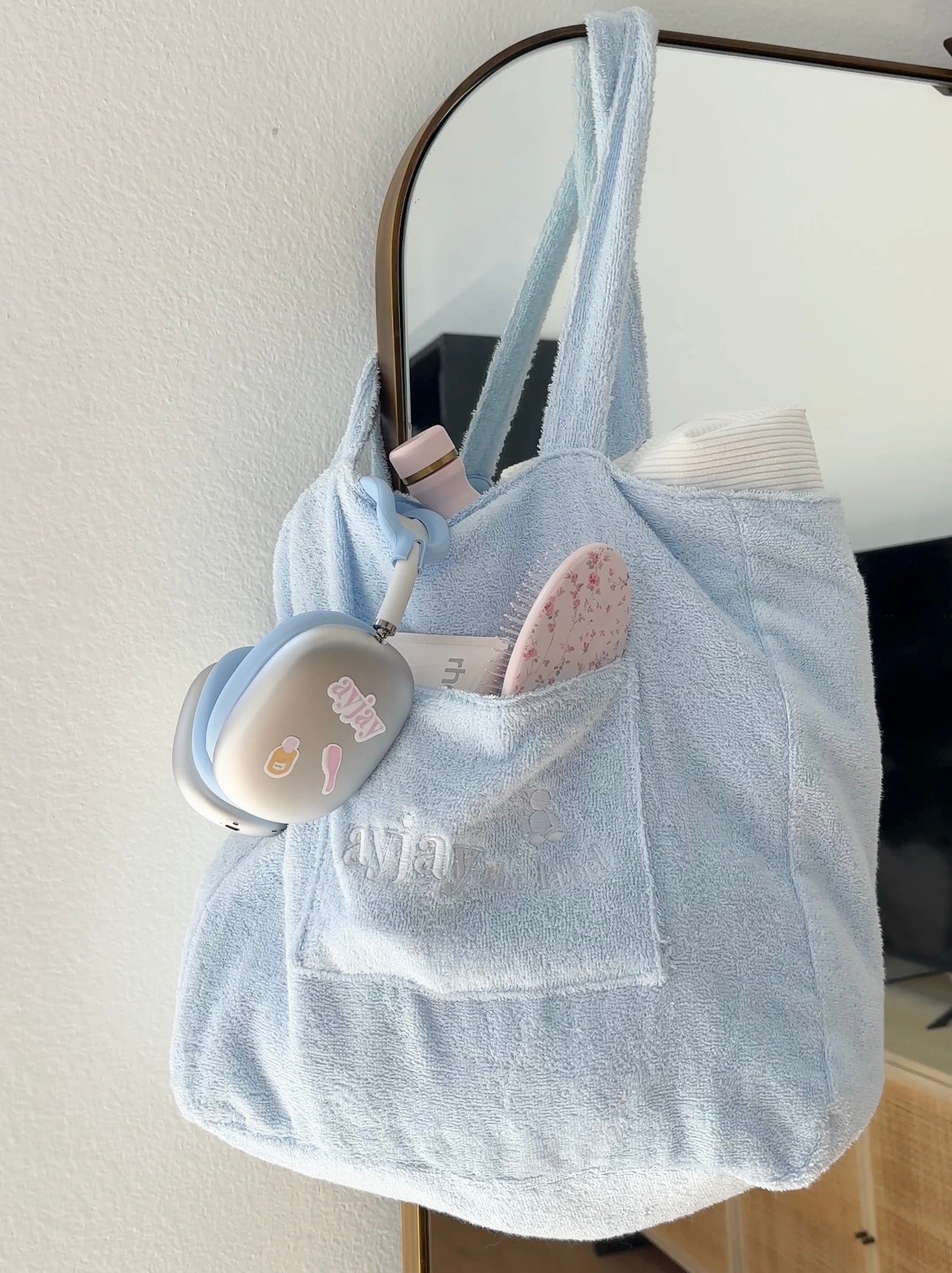 Light blue terrycloth tote bag with carry handles and front patch pocket