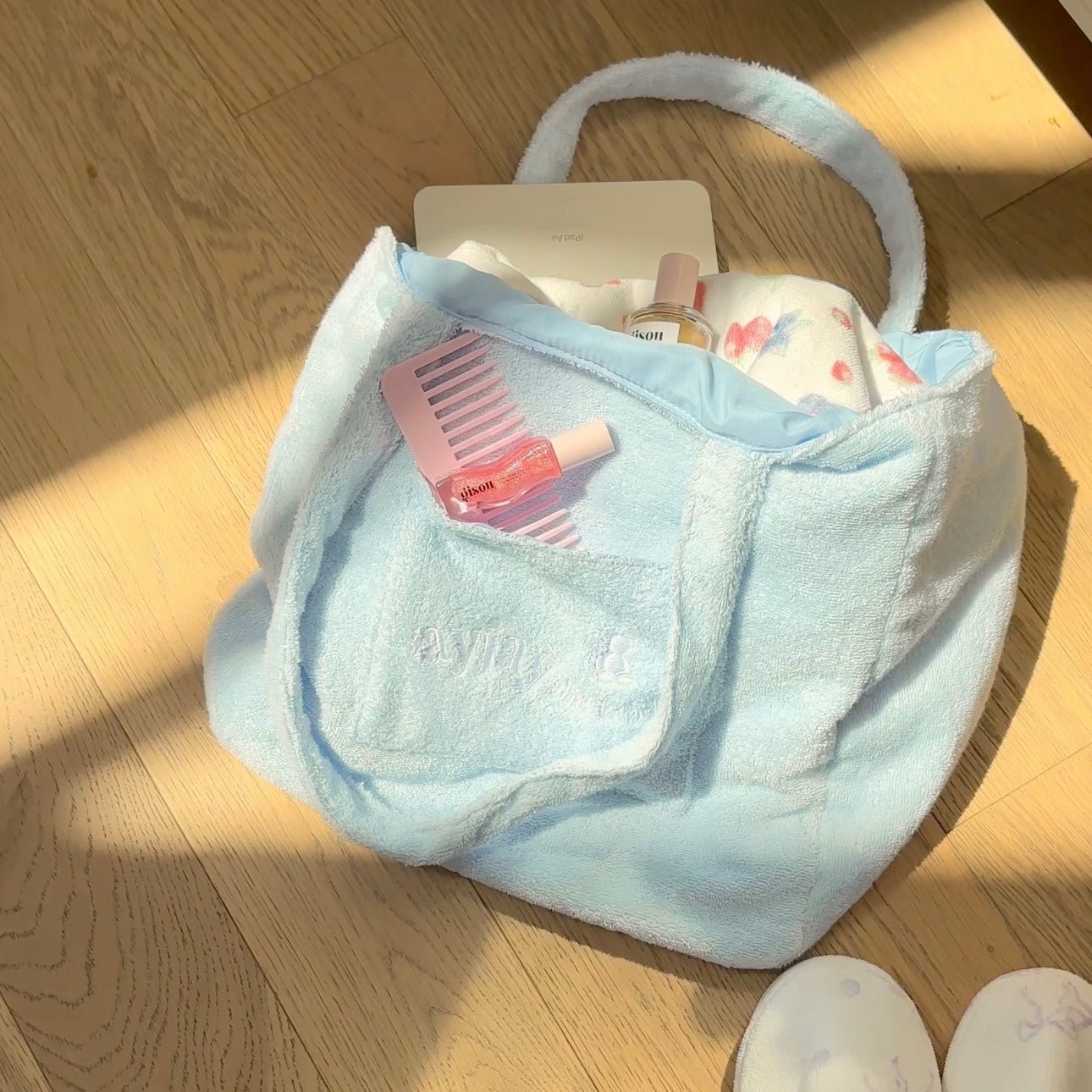 Baby blue terrycloth tote bag with wide open top and curved handles