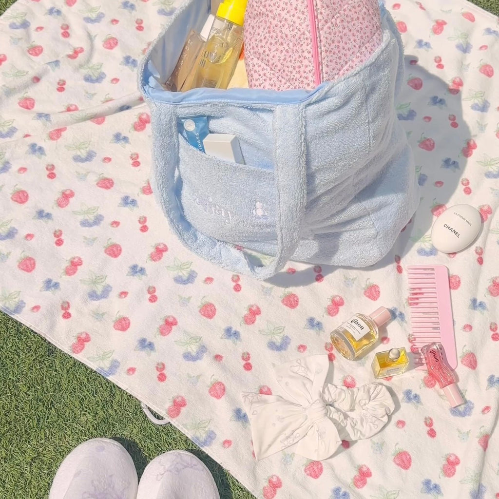 Light blue terrycloth tote bag with inner compartment and front pocket detail