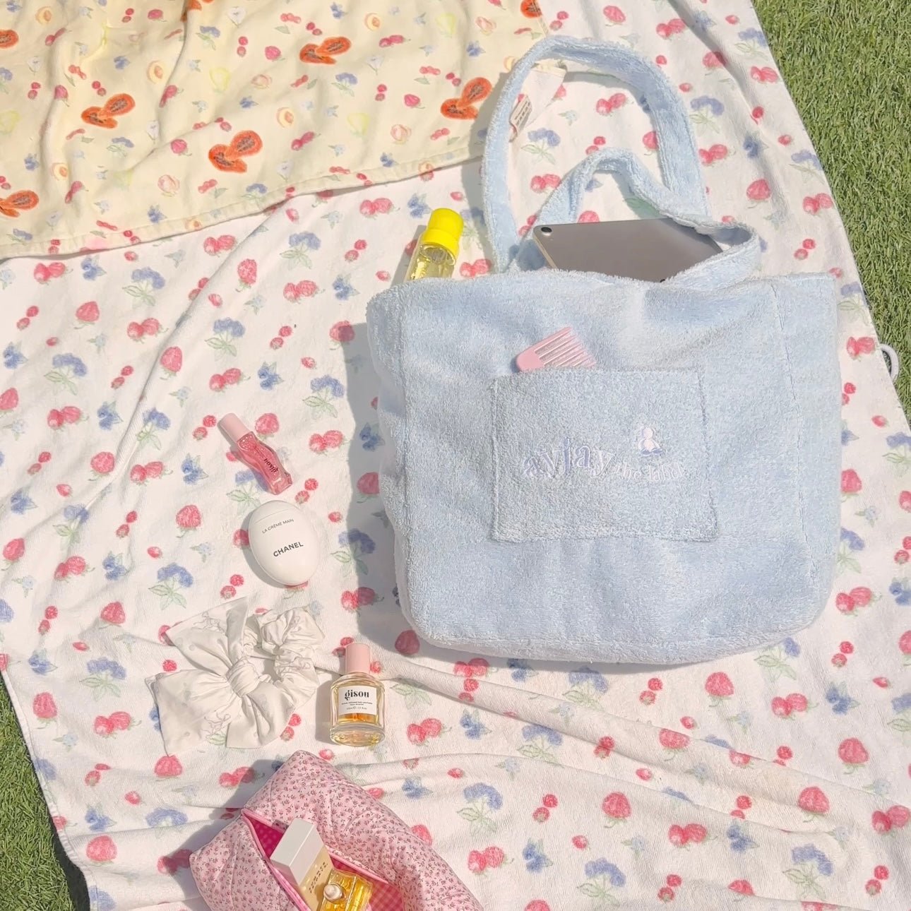 Baby blue terrycloth tote bag with roomy open top and front slip pocket