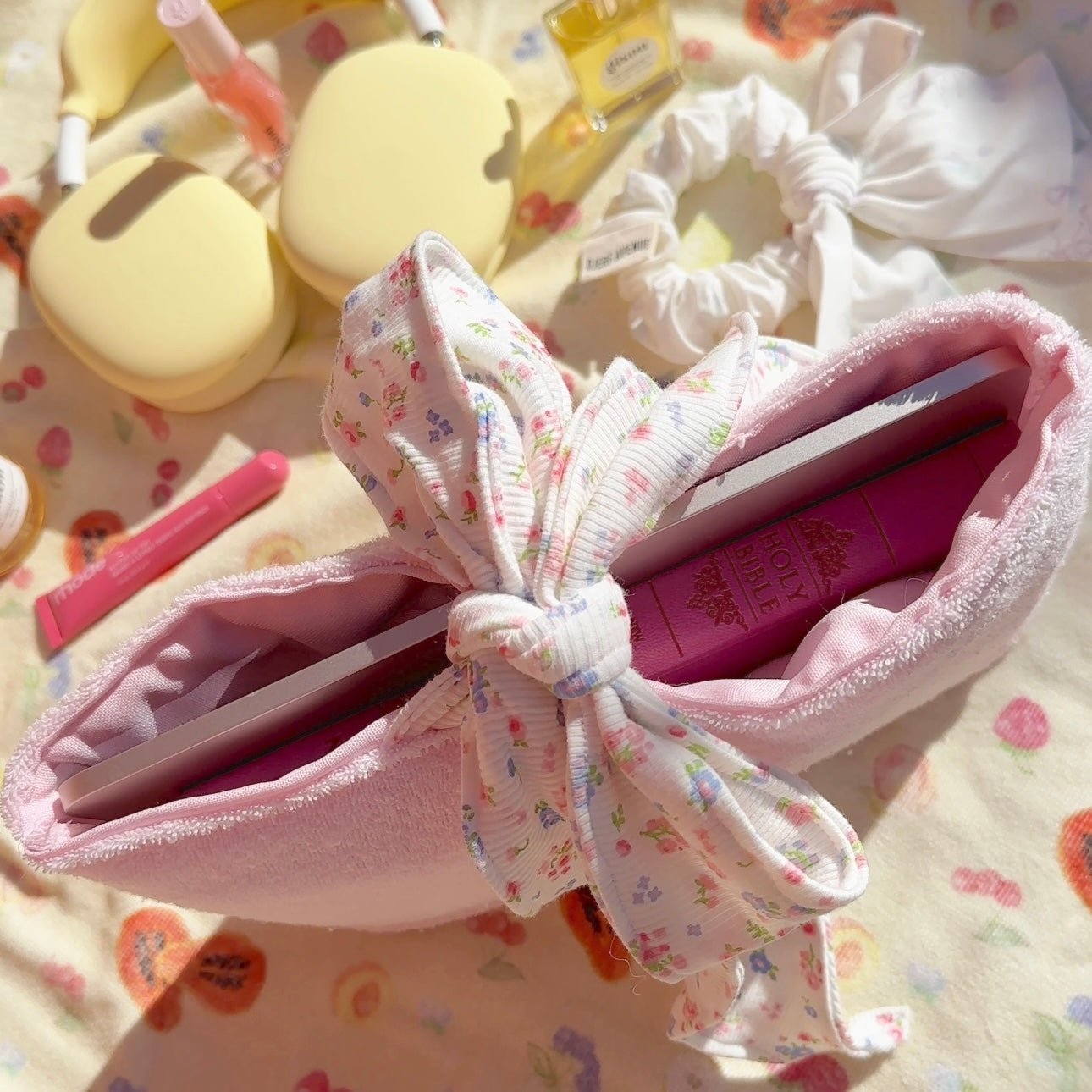 Pink teddy bow Bible sleeve opened showing padded interior and floral ribbon ties
