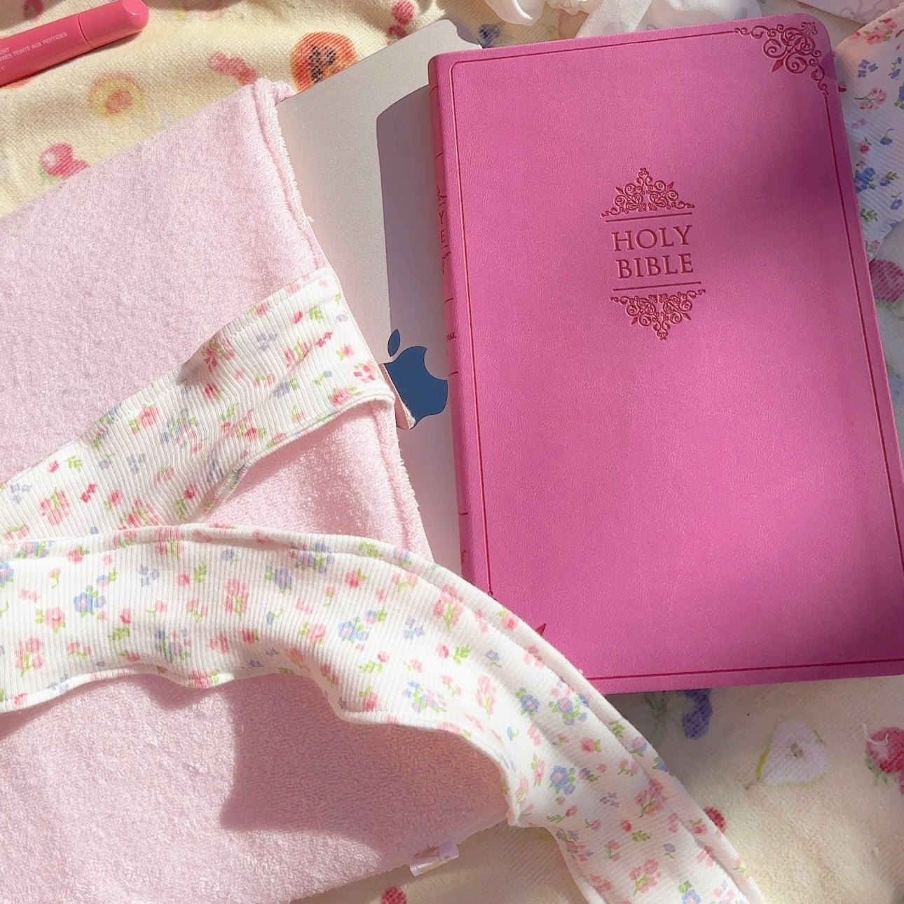 Pink teddy Bible sleeve with floral bow, open to show Holy Bible cover