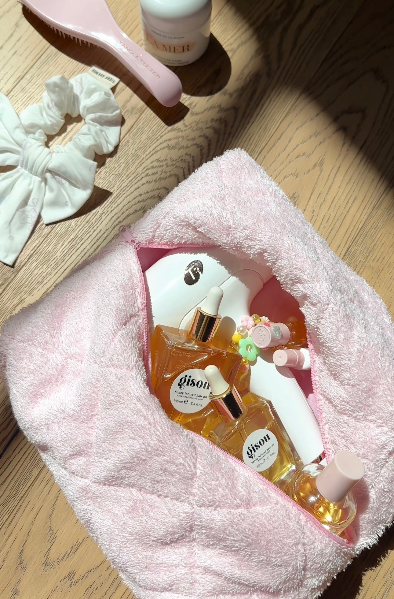 Baby pink terrycloth towel, folded rectangle with pink inner trim