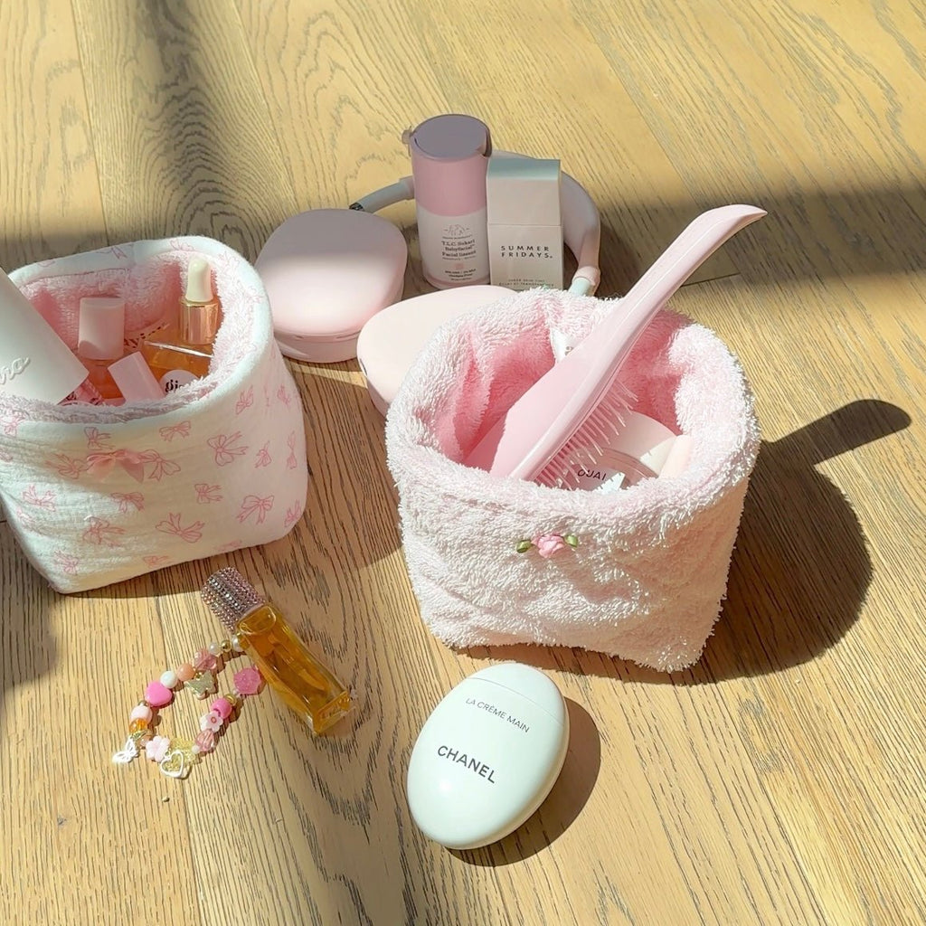 Baby pink terrycloth organizer bin, open top with toiletries and brush inside