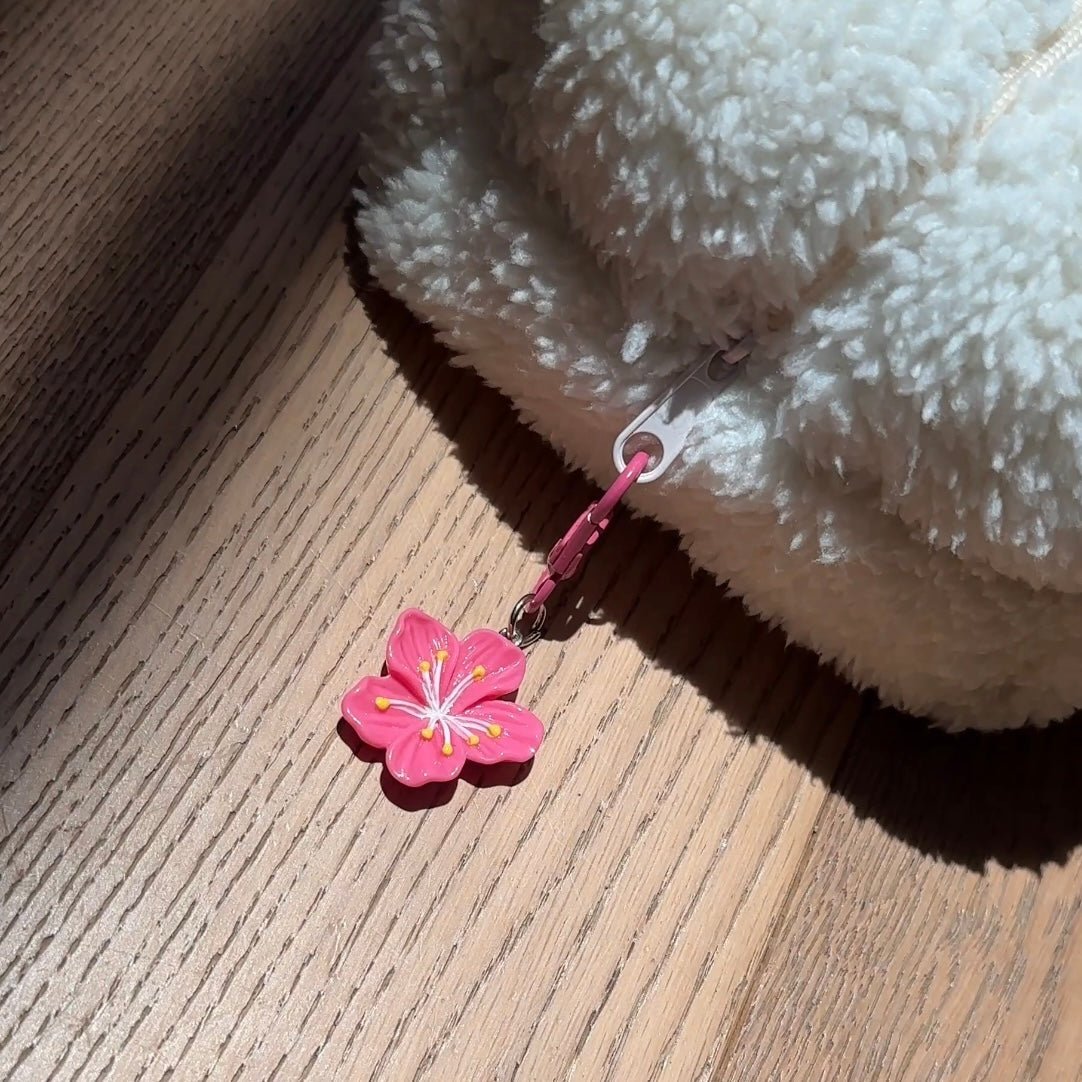 Pink flower bag charm with yellow accents on pink chain clip