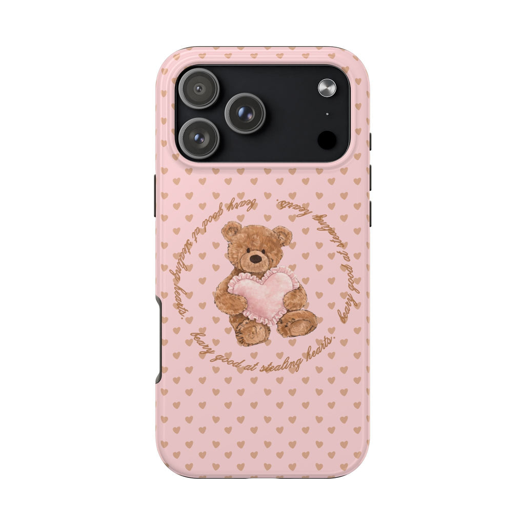 Phone case with pink hearts background and teddy bear graphic centered on the back