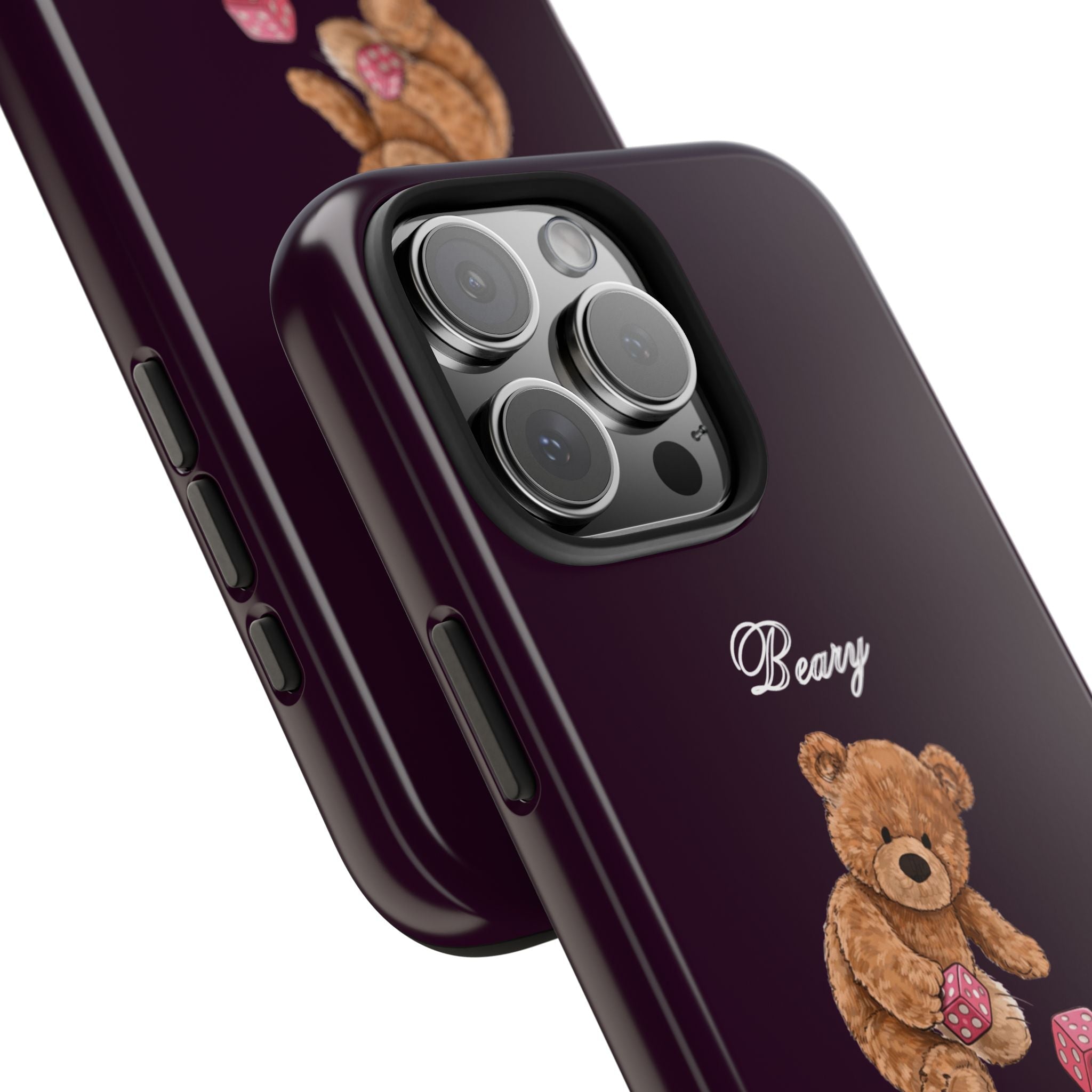 Dark plum phone case angled view: teddy bear detail near bottom, camera lenses, cutout
