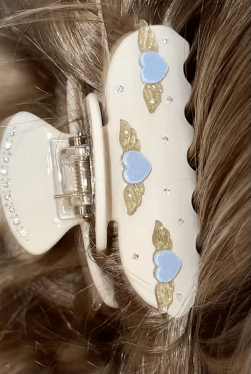 Beige heart hair claw with blue and gold angel-heart charms and rhinestone details