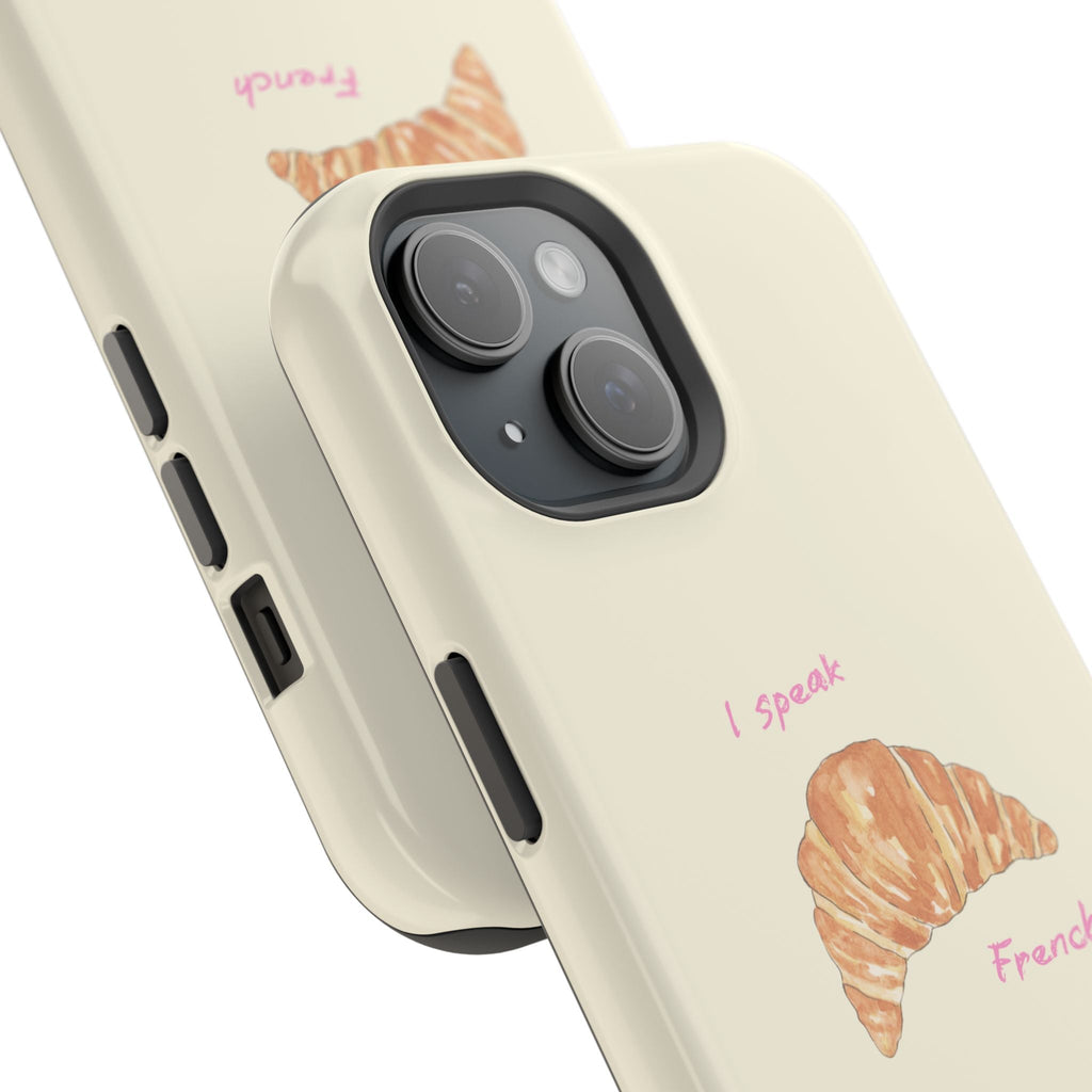 Angle view: beige phone case with croissant art, I speak French, camera cutouts
