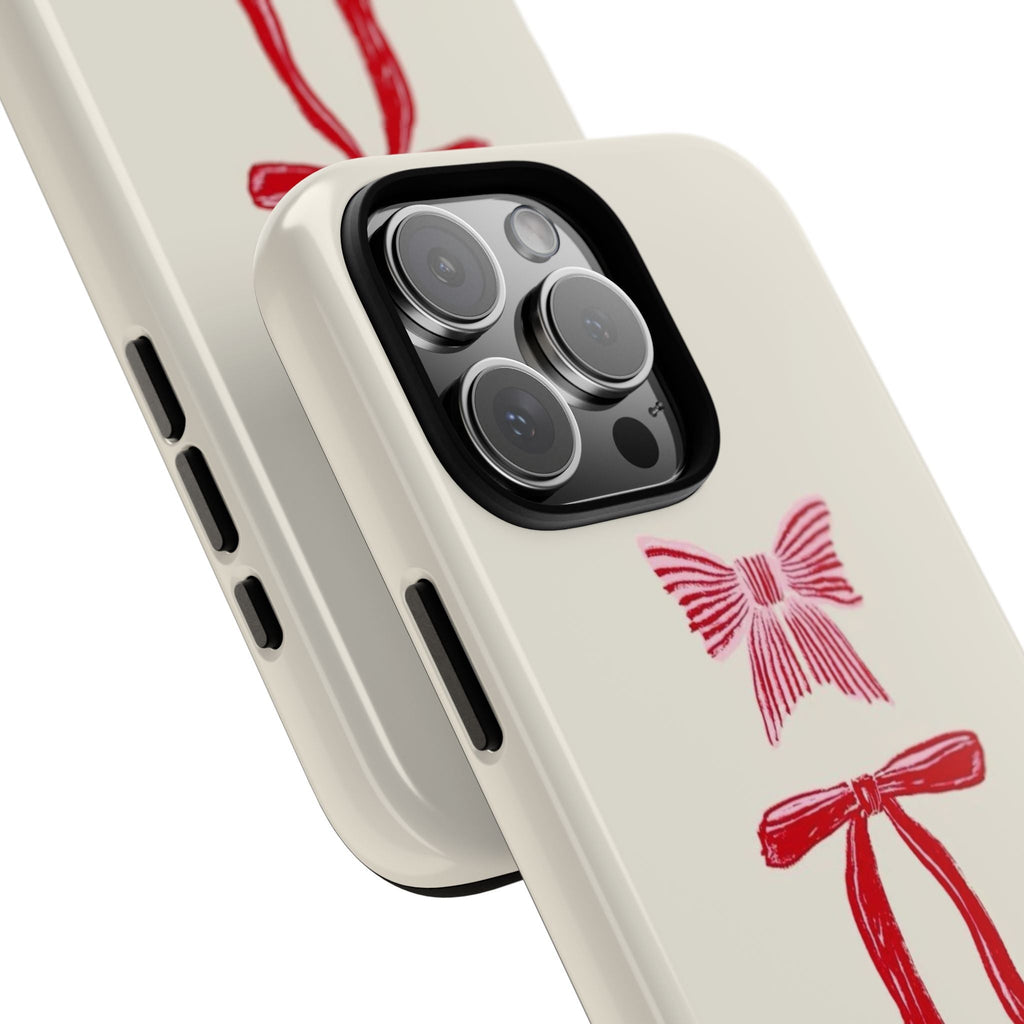 Beige phone case corner with red bow design and camera lens cutout