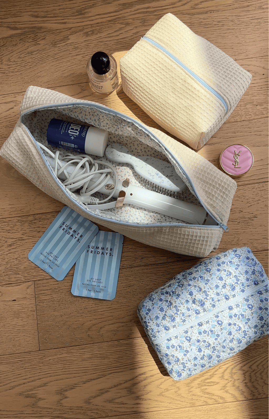Cream waffle-knit zip pouch with light-blue trim and matching pouch, open