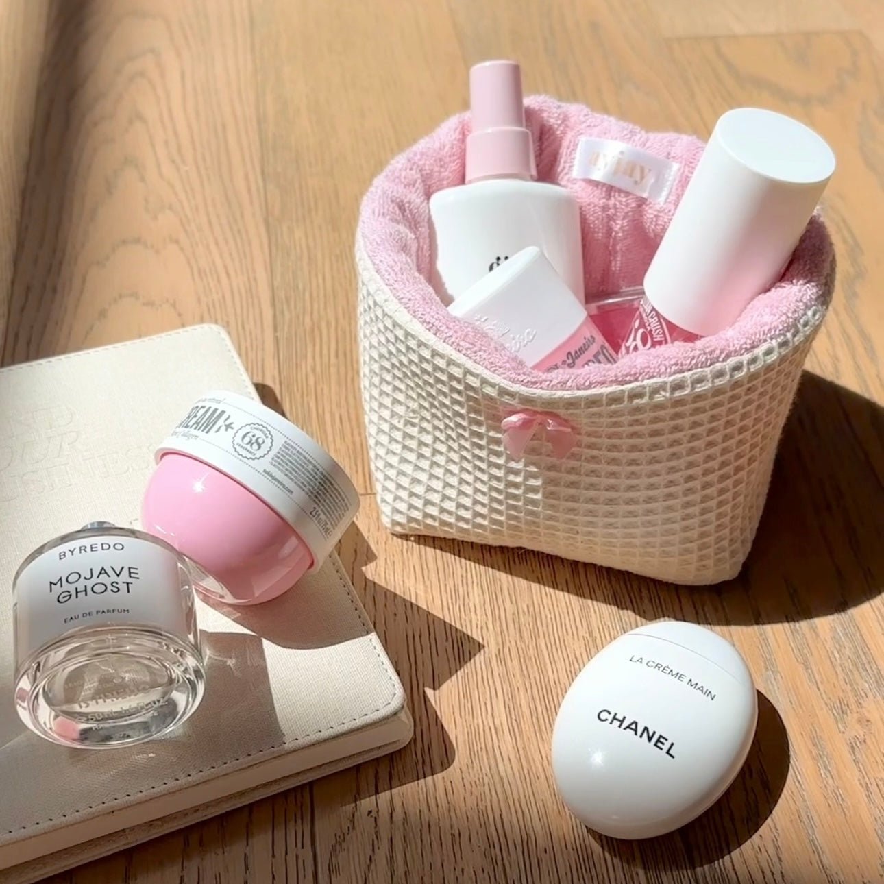 Beige waffle-knit organizer basket with pink textured lining and small bow detail
