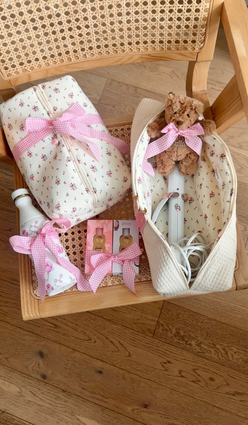 Floral zip pouches with pink gingham bows in beige waffle-texture organizer tray