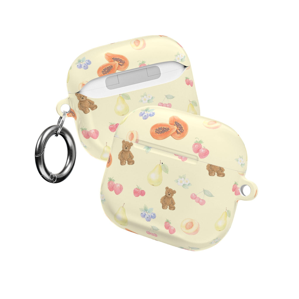 Two-view light cream AirPods case with berry and teddy bear print; top button panel visible