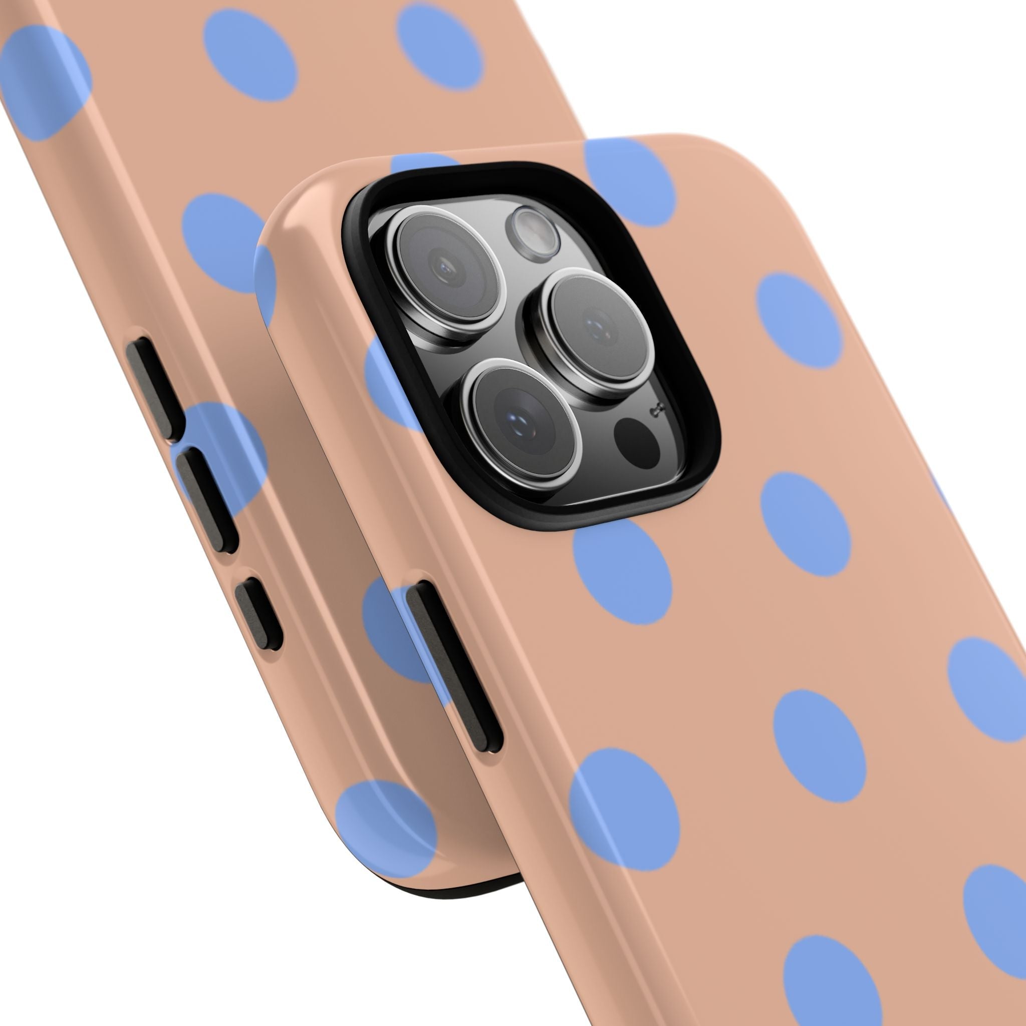 Side-on view phone case with blue polka dots on peach, camera lenses and buttons