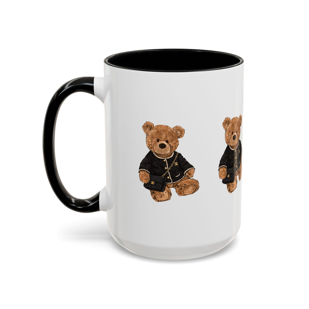 White ceramic mug with black handle and rim, teddy bear graphic on side