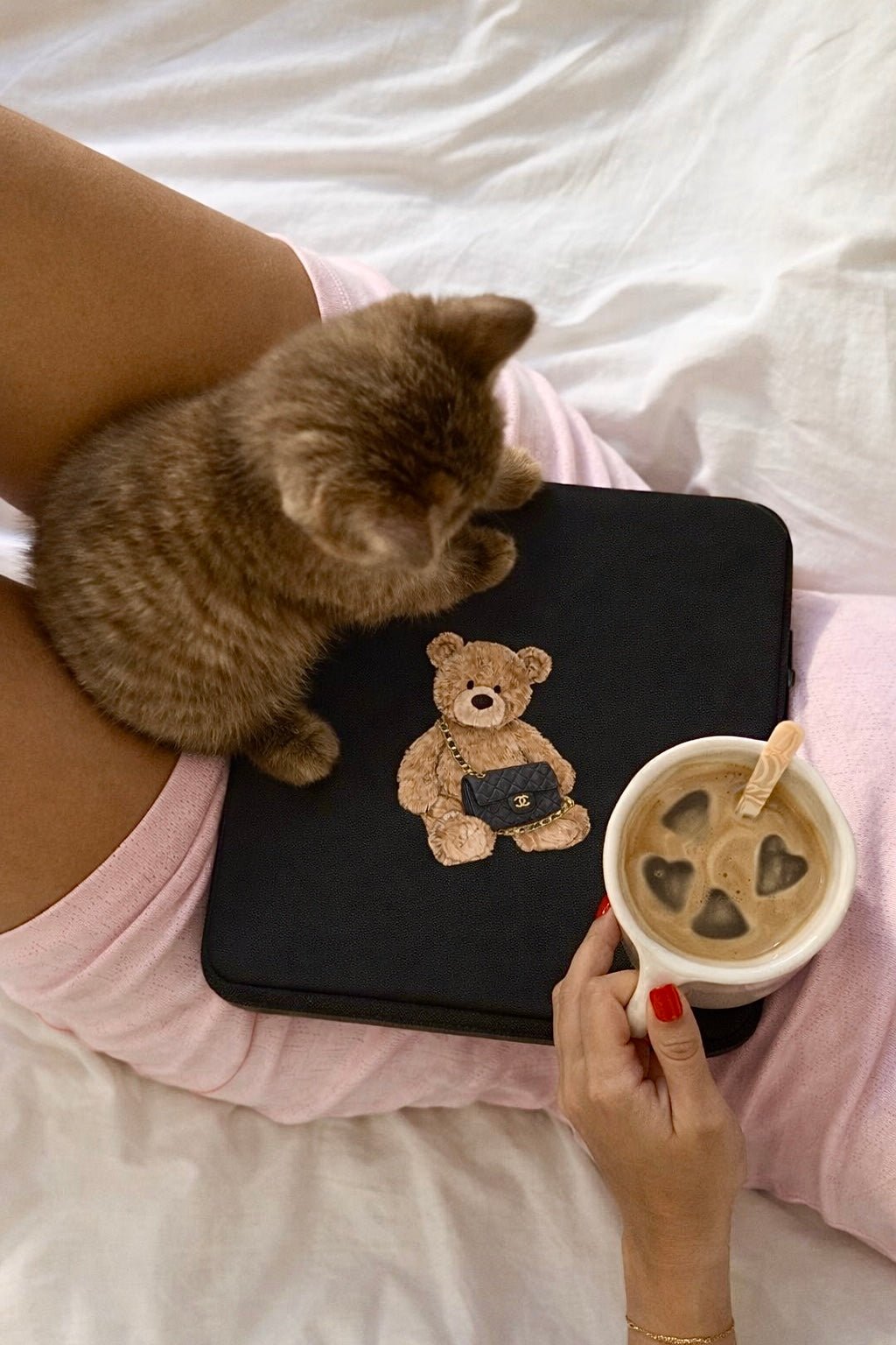 Black device sleeve with teddy bear patch and plush teddy head detail