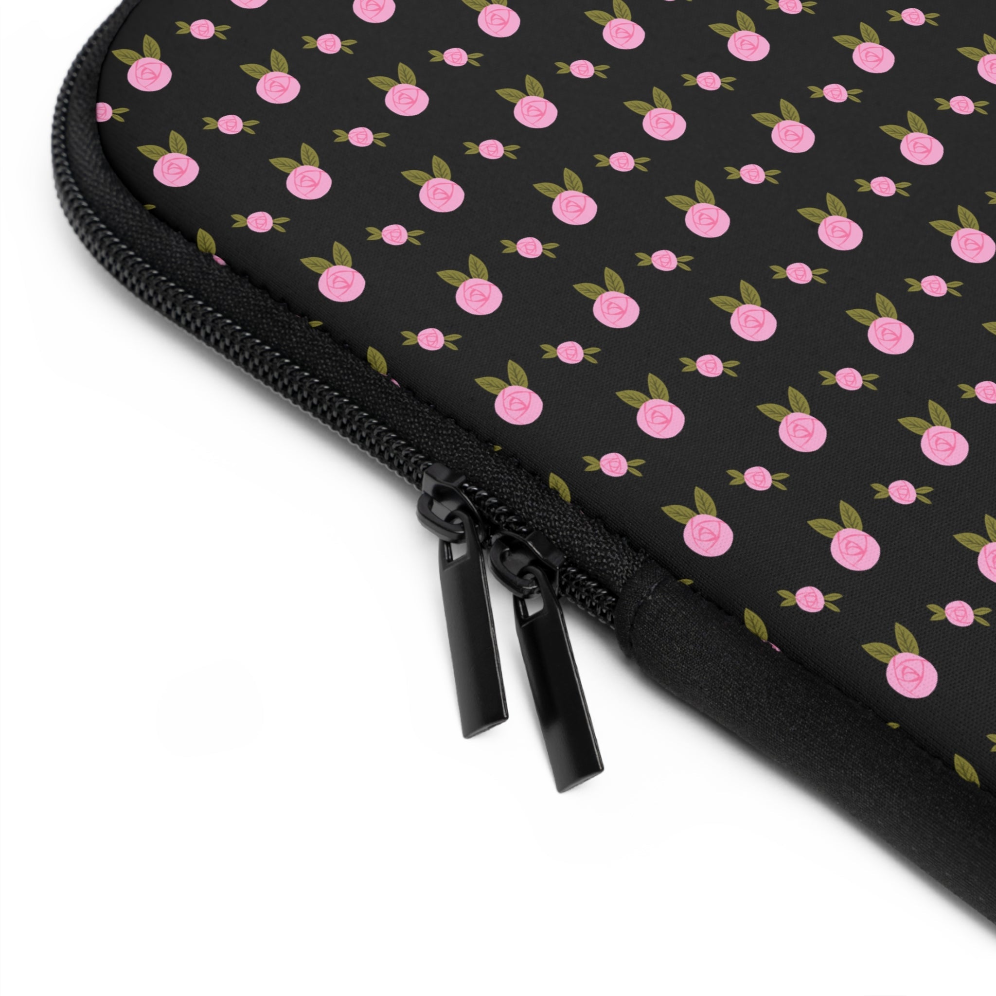 Close-up of black zipper on pink ditsy floral neoprene sleeve edge