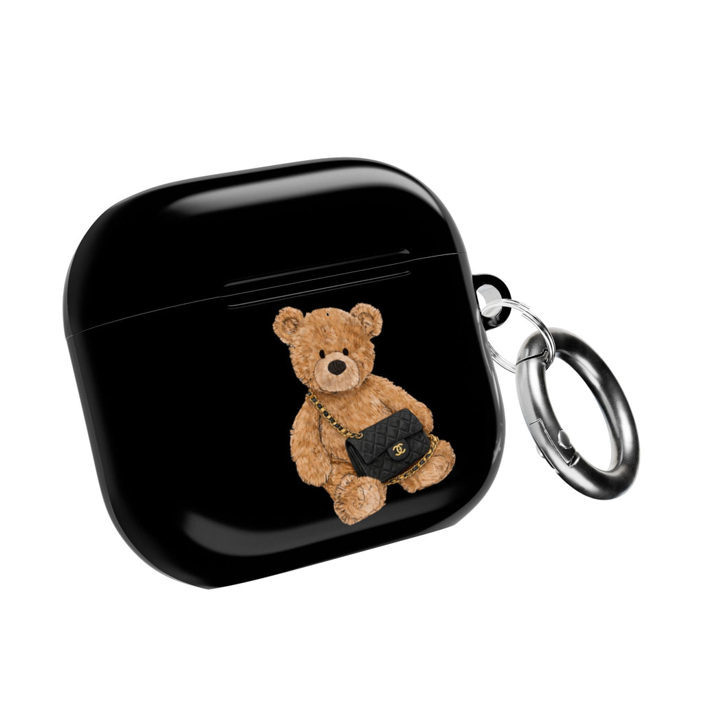 Black flap AirPods case with teddy bear patch and metal key ring, closed