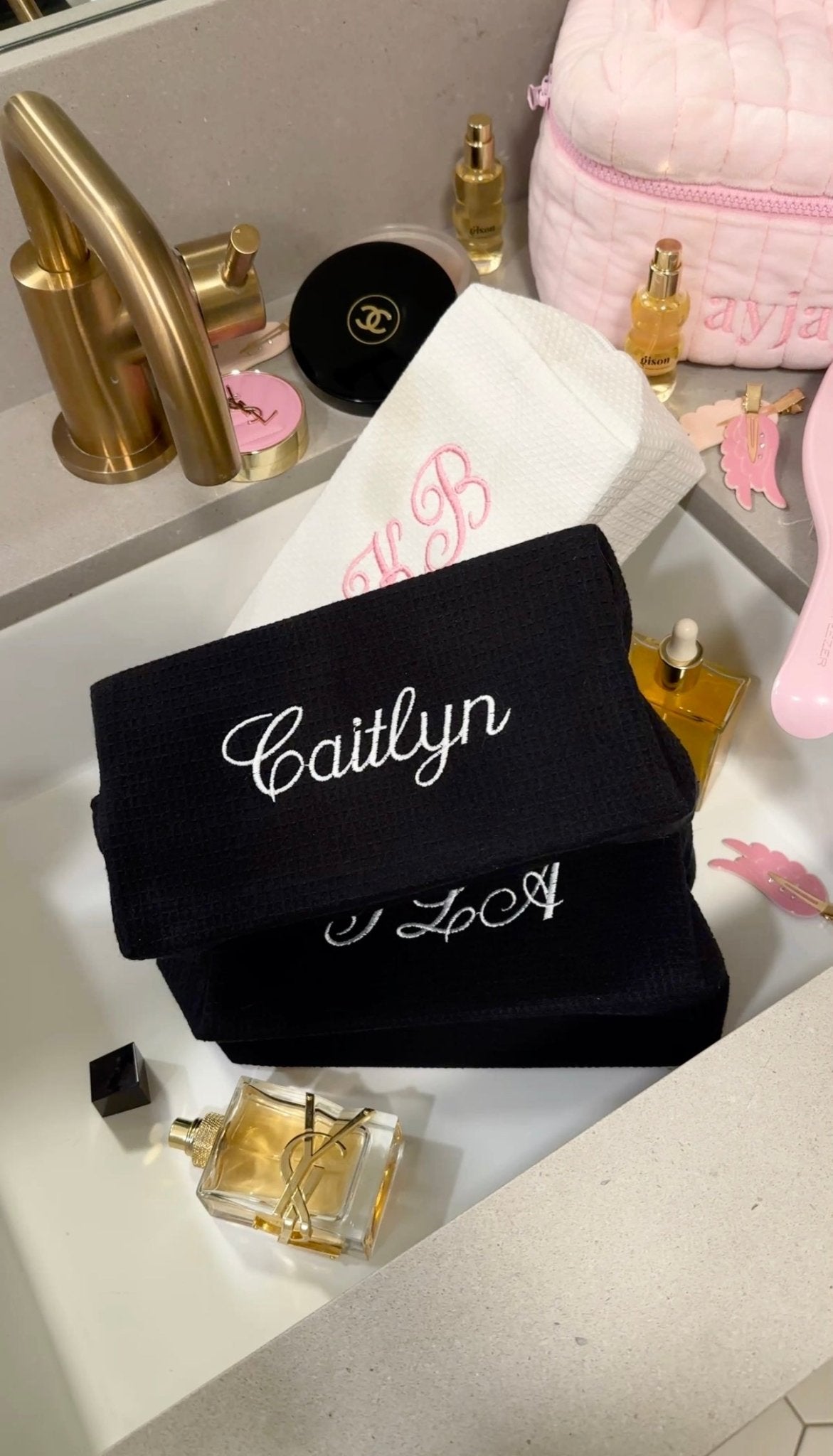 Black waffle knit custom embroidery bag with white 'Caitlyn' and 'LoA' lettering