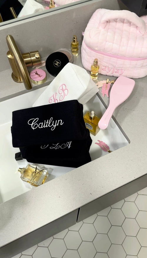 Black waffle knit custom embroidery bag with white 'Caitlyn' on front