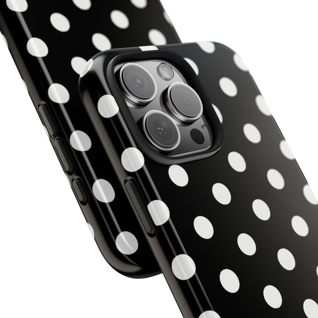 Black phone case with white polka dots; close-up of camera lens cutout