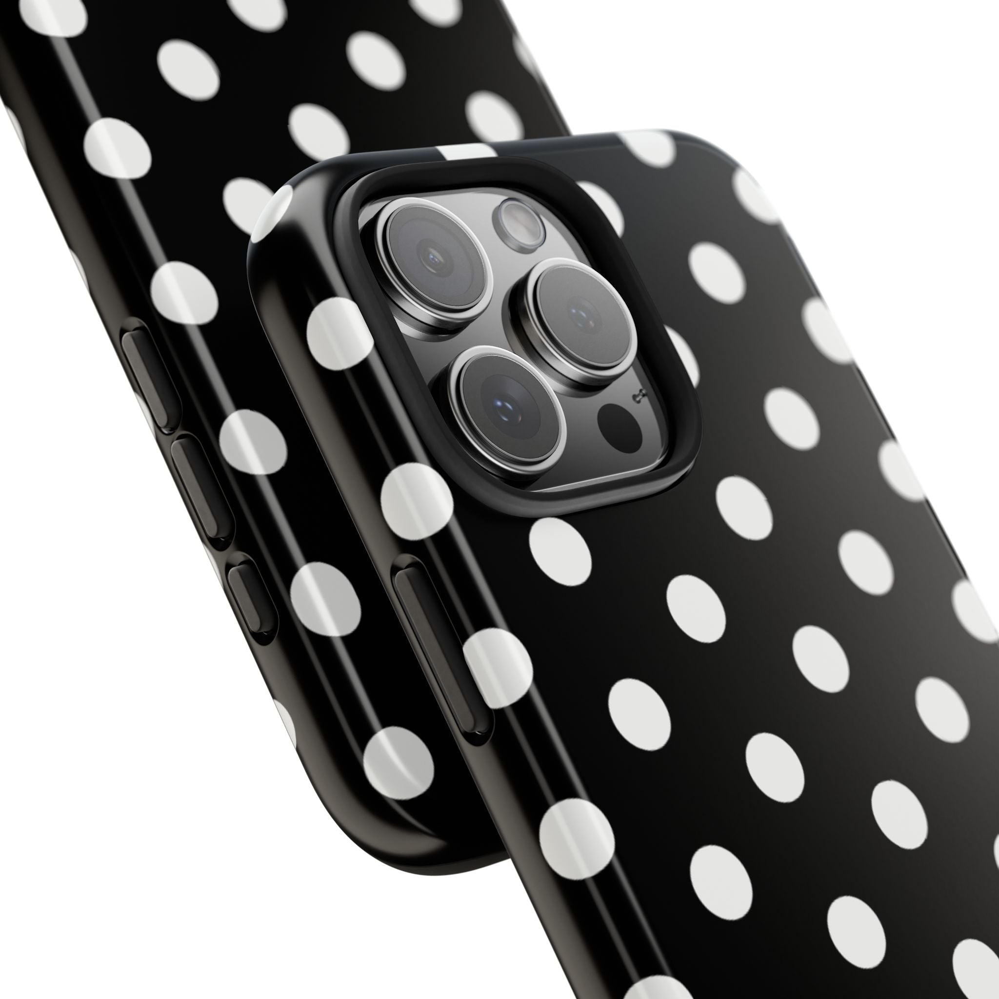 Close-up of black polka dot phone case edge and triple camera openings