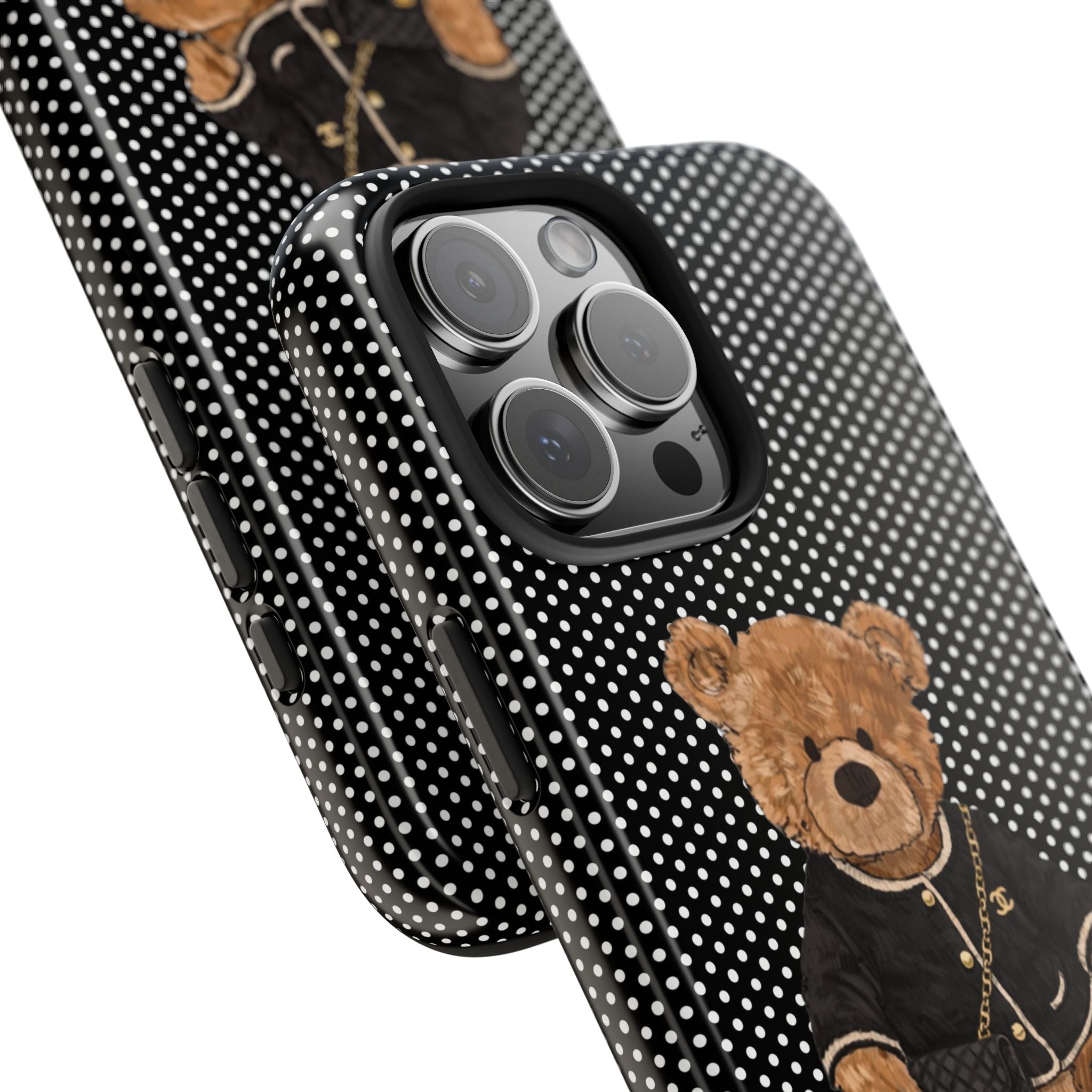 Polka dot phone case with teddy bear, angled view showing camera cutout and raised edges