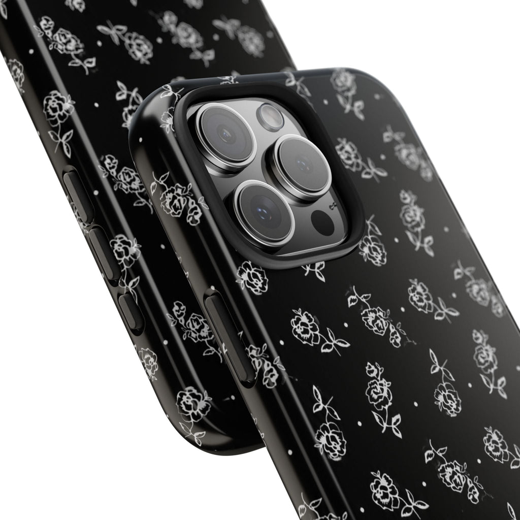 Close-up angled view of black phone case with white rose pattern and side buttons