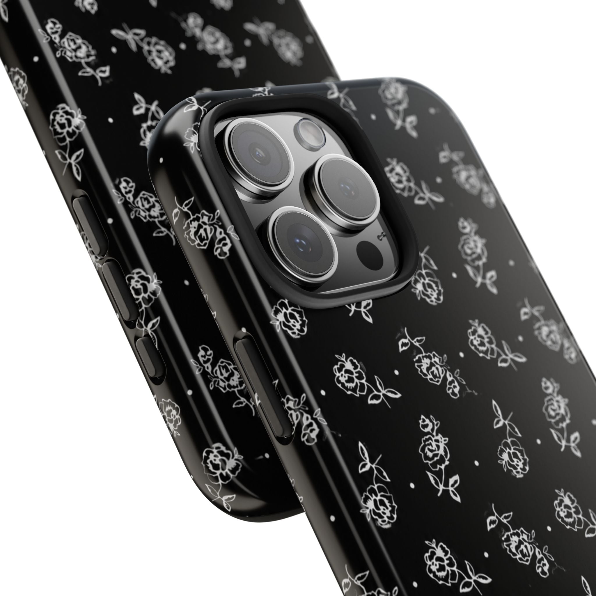 Close-up angled view of black phone case with white rose pattern and side buttons