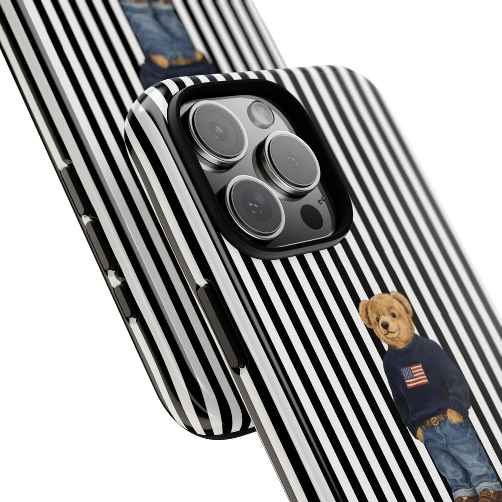 Black-and-white striped phone case with teddy bear figure near camera cutout