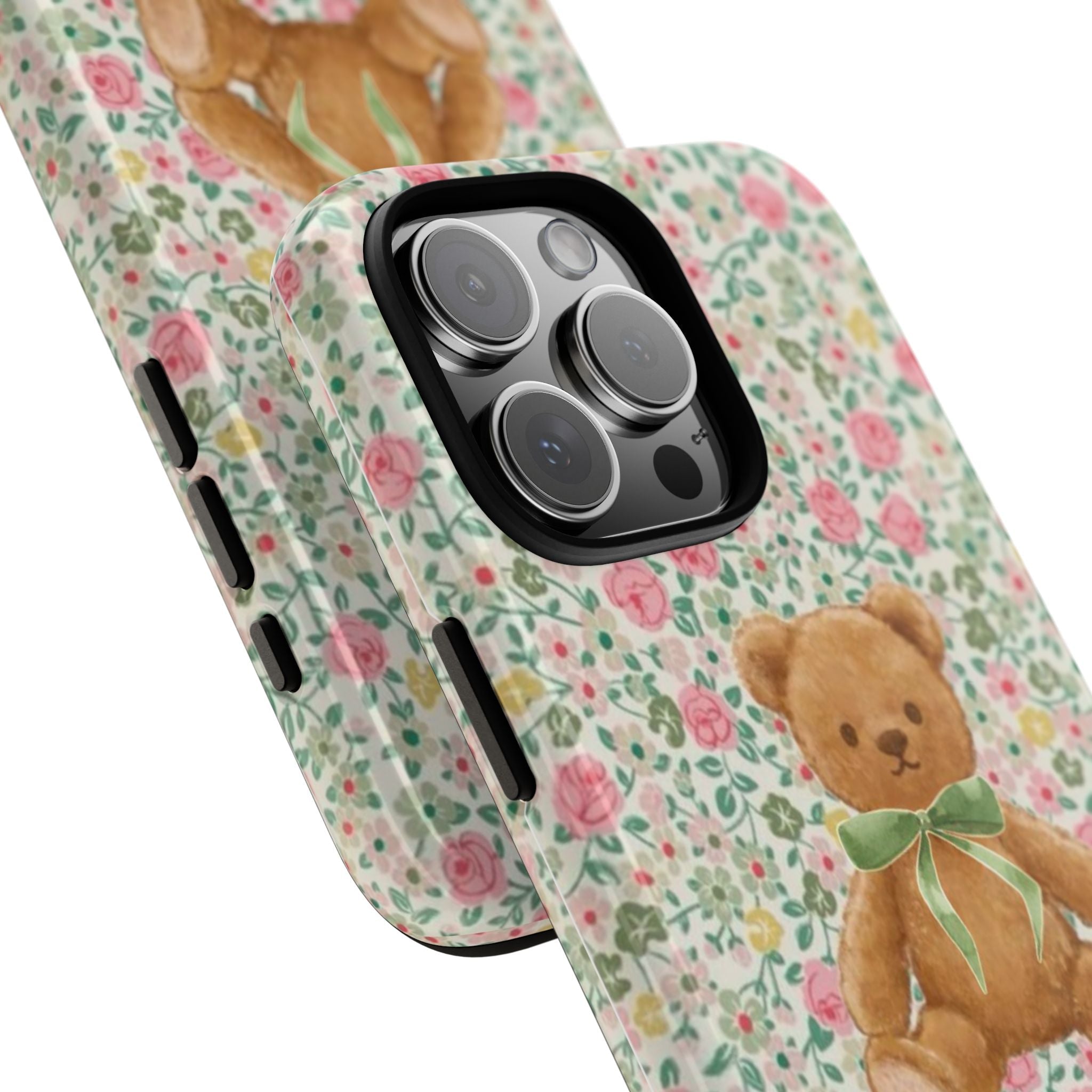 Angled view of floral phone case with teddy bear design and visible side button openings