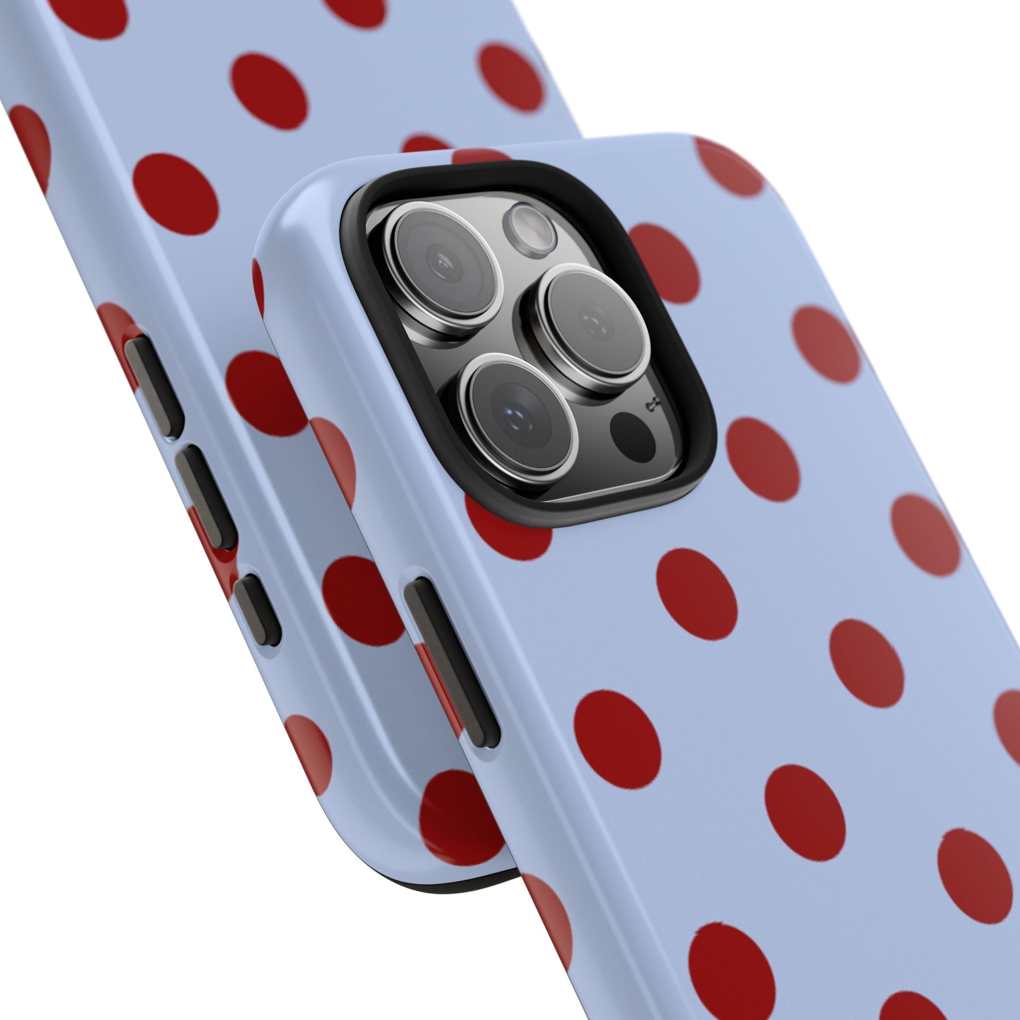 Close-up of light blue phone case with red-burgundy polka dots and camera lenses