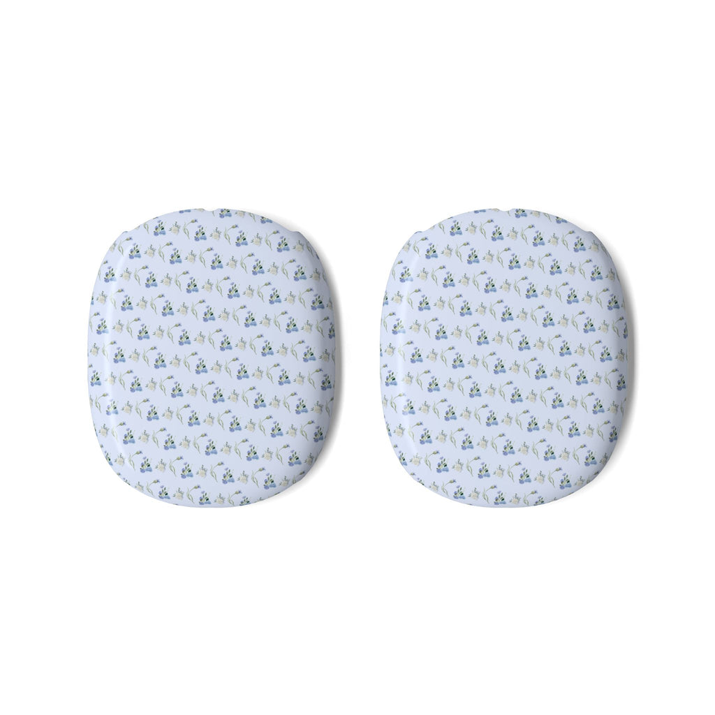 Pair of AirPods Max ear cup covers with blue ditsy floral pattern on light fabric