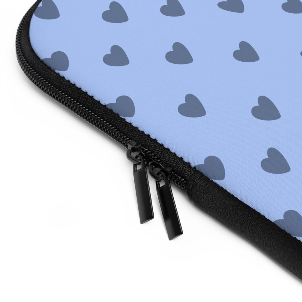 Close-up of black zipper on light blue neoprene sleeve with grey heart print
