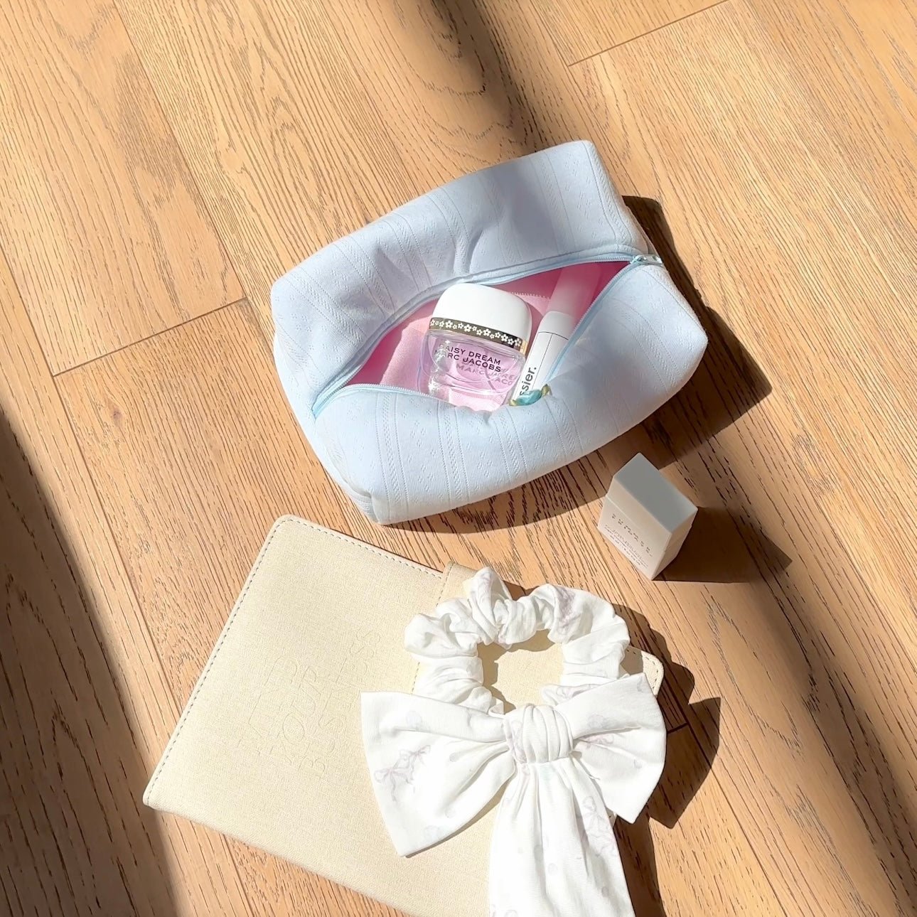 Light blue lace-knit open zip pouch; cream pouch with bow