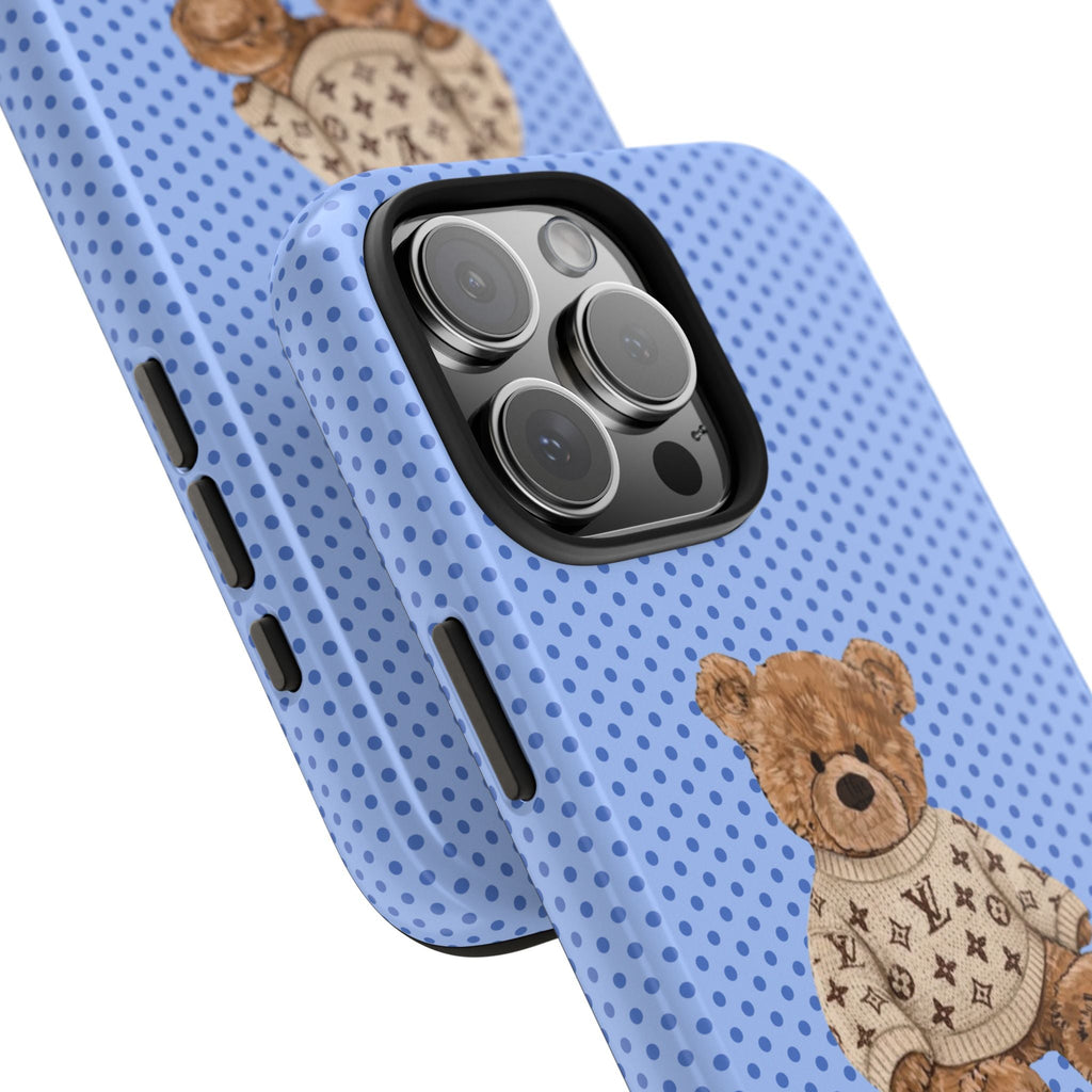 Blue polka-dot phone case with teddy bear sweater near camera cutout