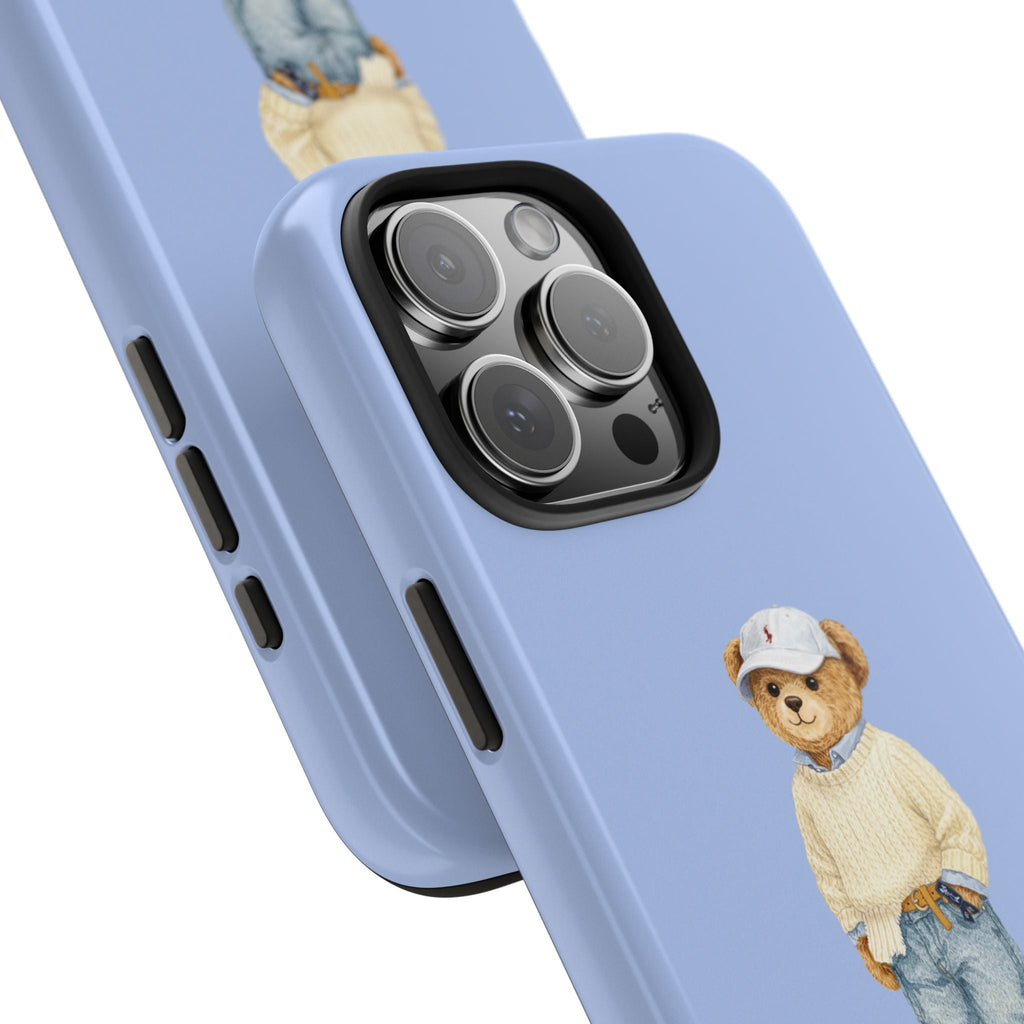 Light blue phone case with teddy bear figure and camera cutouts, angled view