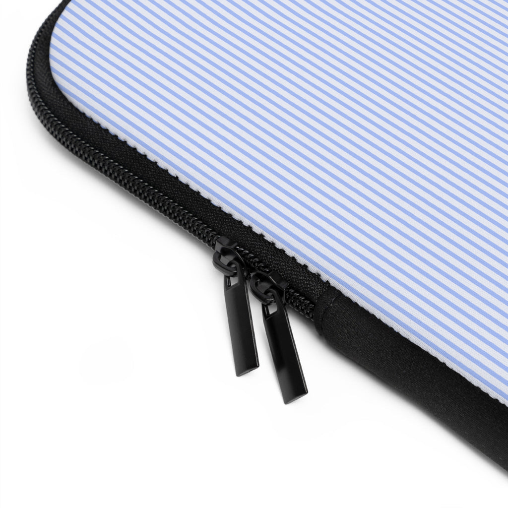 Close-up of black zipper on light blue striped neoprene sleeve with black piping