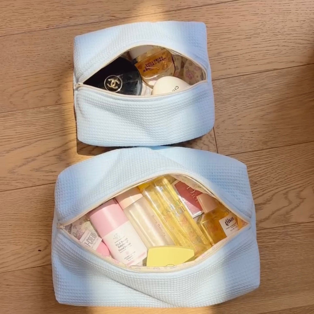 Set of light blue waffle-knit zip pouches, both open
