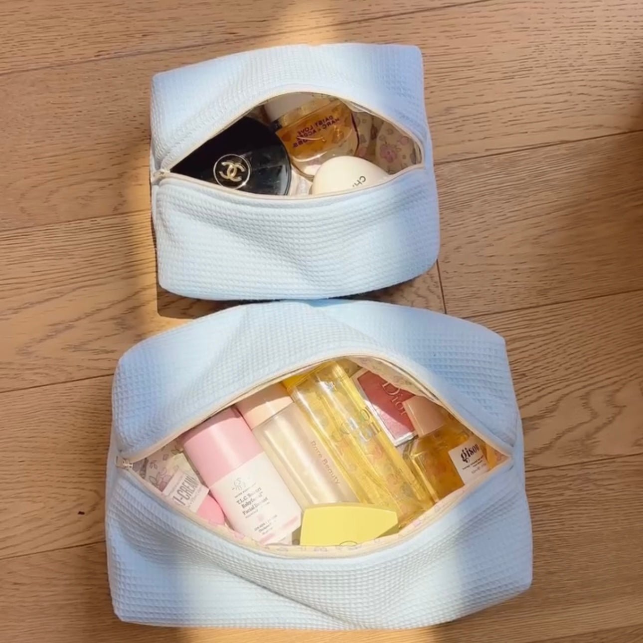 Set of light blue waffle-knit zip pouches, both open