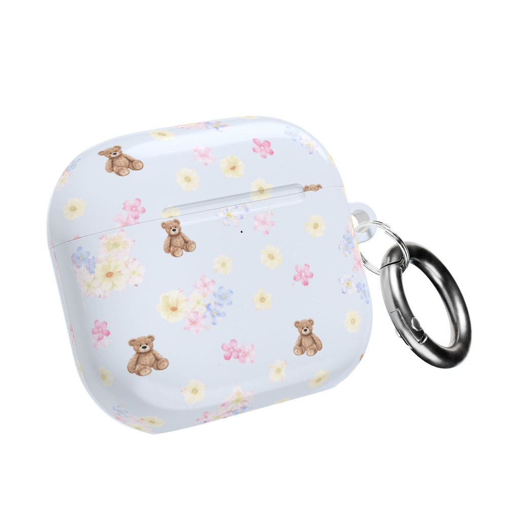 Light blue AirPod case with floral bear print, closed, with metal keyring.