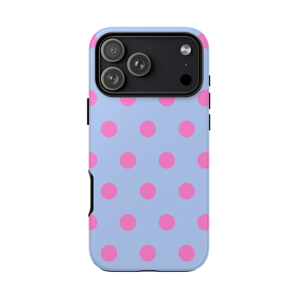 Light blue phone case with pink polka dots; raised camera cutout and side buttons visible
