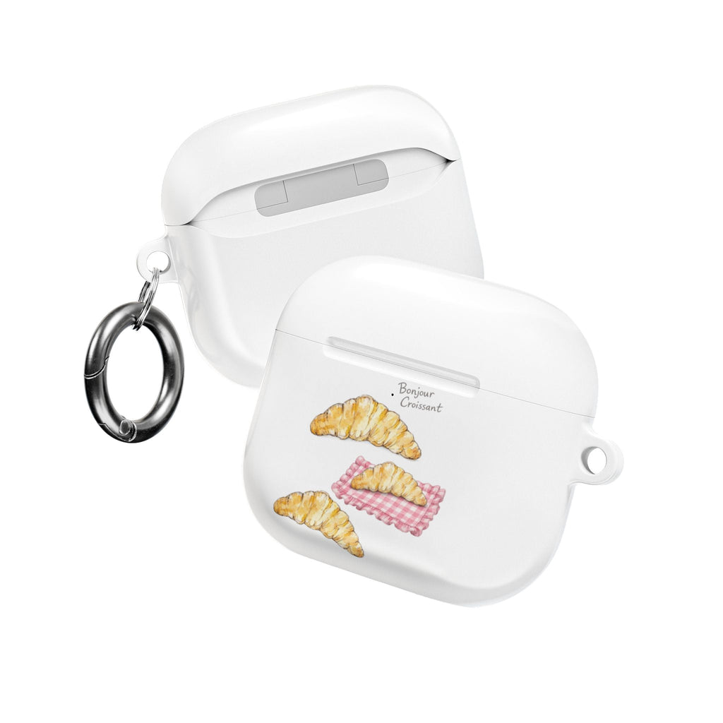 Two-piece view of white AirPods case with croissant and pink checker graphic, with keyrings