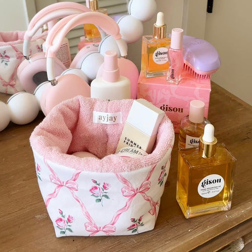 Pink floral organizer with soft pink interior and white fabric bin for storage