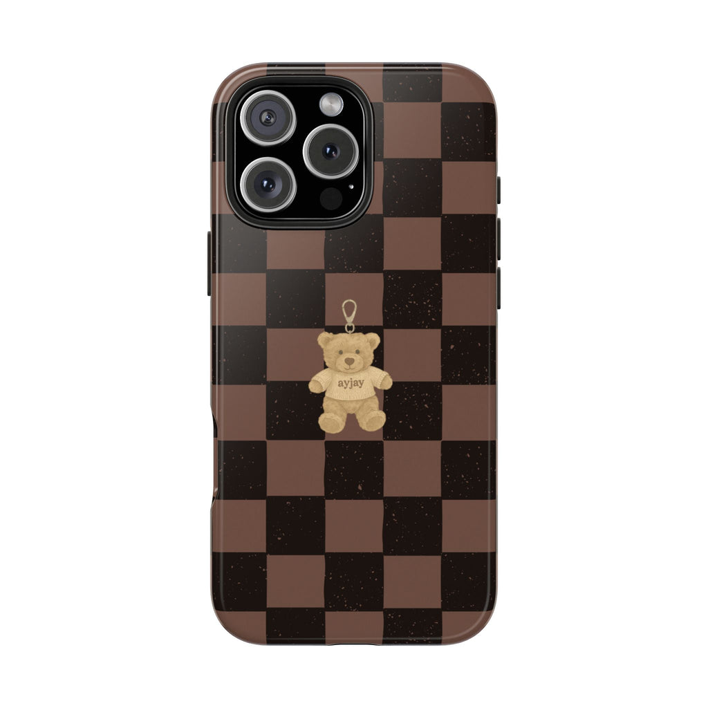 Brown checkered phone case with teddy bear holding tag, centered graphic and camera cutouts